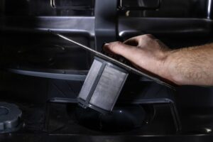 man removing dishwasher filter